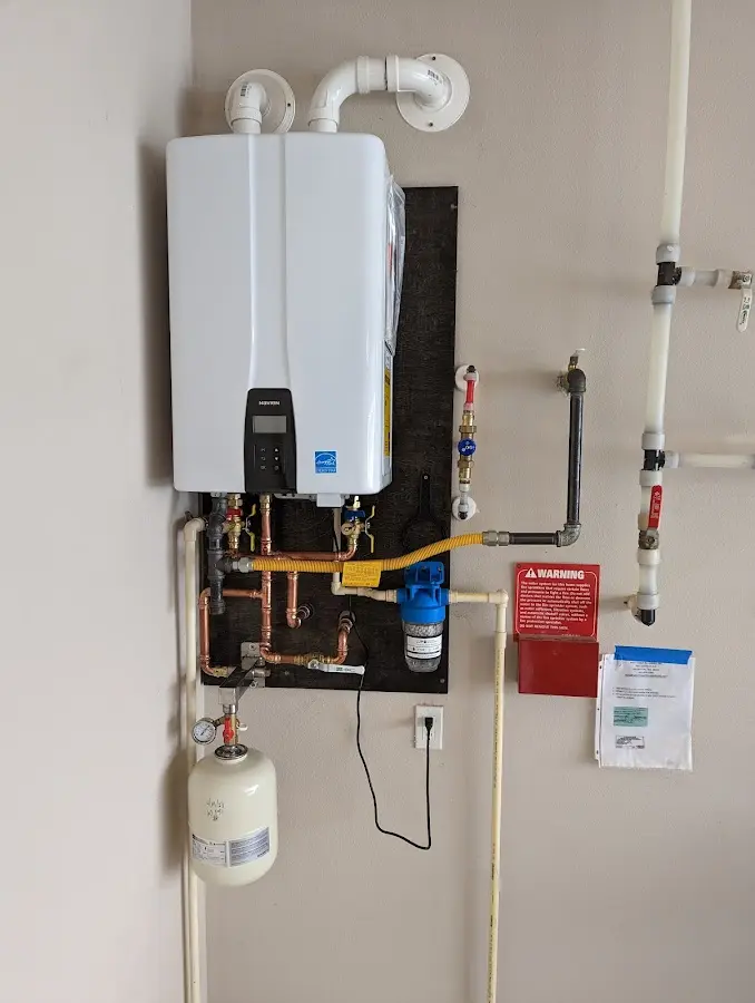 Professional plumber installing copper piping in a San Carlos home